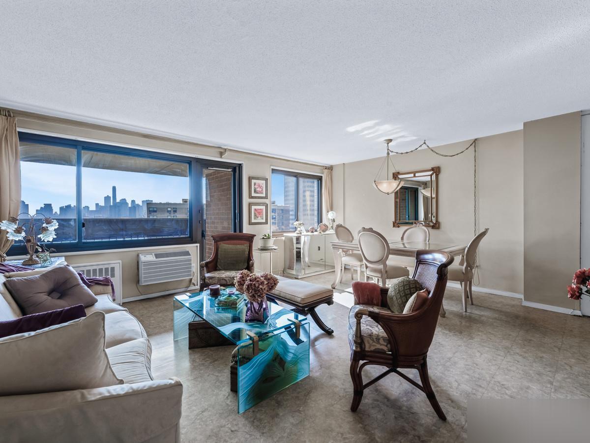 Southbridge living and dining room with Lower Manhattan skyline framed by the windows