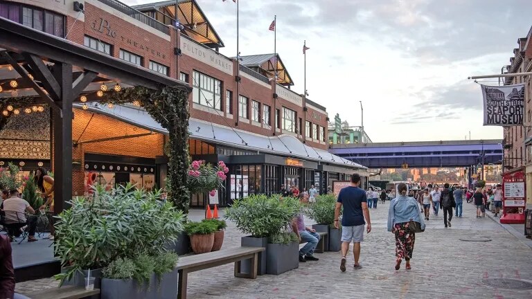 South Street Seaport's cobblestone walkway and the restored Fulton Market hall